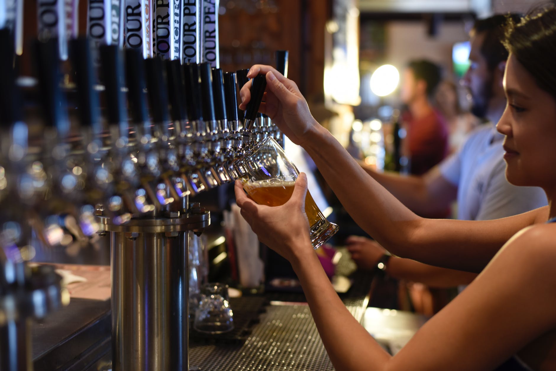 pan holding pilsner inside bar